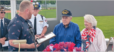 Photo by Dwayne Bradley Commission Chairman Dr. Rob Peck, left, and Betty Bradley honor 100-year-old veteran, Ralph Myers during the dedication of the Veterans Park on Memorial Day. The day combined two events, remembrance of those who sacrifi ced their lives for their country and the debut of the park honoring all veterans. In the foreground are veterans Carl Maxwell and VFW Commander John Clodfelter who led the Memorial Service.