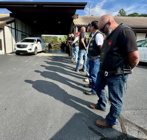 Randy Foster/editor@cherokeescout.com Veterans and law enforcement personnel stand in formation as the casket bearing the remains of Transport Detention Officer Francisco Flattes is removed from a hearse at Townson-Rose Funeral Home on Thursday, July 3. Flattes’ remains were returned to Murphy following an autopsy in Winston-Salem, with an escort by emergency responders.