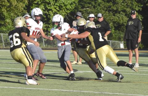 Gary Corsair • Clay County Progress Luke Buckner, No. 1, tries to strip the ball from an Andrews Wildcat as Yellow Jackets Jake Frentz, No. 78, and A.J. Austin, No. 56, move in for the tackle during a JV scrimmage in Hayesville.