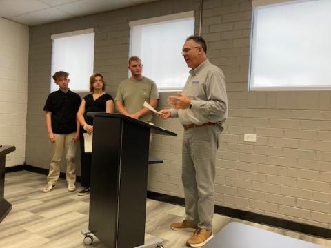 Marcia Barnes • Clay County Progress High School Principal Stacey Overlin, right, presented award certifi cates to, from left, Dalton Hunt, Cailey Bowers and Wyatt James for achievement in their summer experiences.