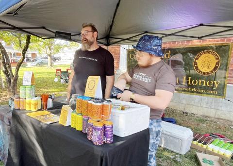 Deby Jo Ferguson • Clay County Progress From left, Ted Dunham and Gabe Smith, of Wherloom Honey & Meadery of Robbinsville, gave information for their unique honey products to those who tasted mead for the first time at last  years event.