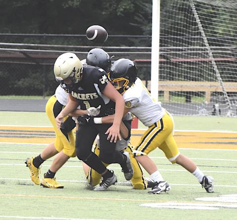 Gary Corsair • Clay County Progress Hayesville quarterback Luke Buckner, No. 1, tries to free himself so he can grab a fumbled football.