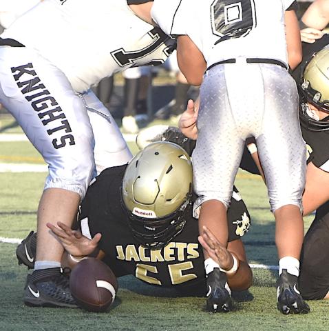 Gary Corsair • Clay County Progress Hayesville lineman Brock Garrett, No. 55, keeps his eyes on the prize as he reaches to recover a Robbinsville fumble