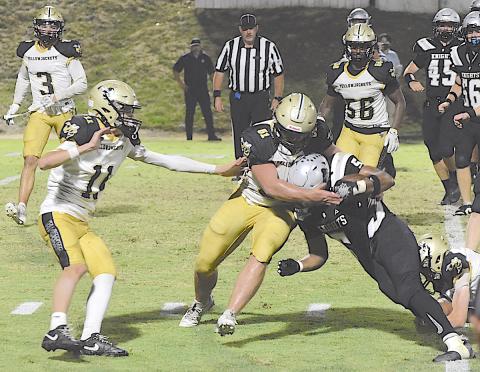Gary Corsair • Clay County Progress Hayesville's Brendon Collins, No. 51, applies a bear hug to a Robbinsville back as Donivin Soto, No. 11, Colton Bruggers, No. 3, and Will Brown, No. 56, hustle over to assist.