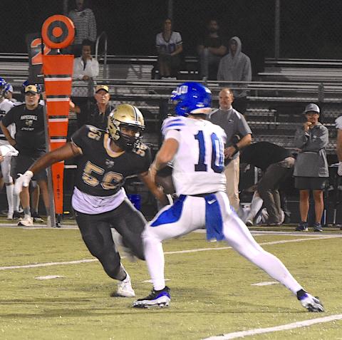 Hayesville sackmaster Will Brown, 56, draws a bead on the quarterback during Hayesville's 35-22 victory.