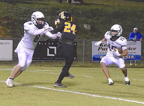 Photo by Gary Corsair Elio Murillo, No. 15, jukes a Murphy defender as he breaks a 28-yard kickoff return for Hayesville’s longest gain of the night. That’s Brett Hanna, No. 8, throwing the block.