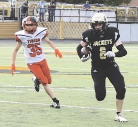 Gary Corsair • Clay County Progress Brett Hanna, No. 8, sets his sights on the end zone as he finds daylight around left end. Hanna scored on runs of 41 and 45 yards and split the uprights on two point-ofter kicks.