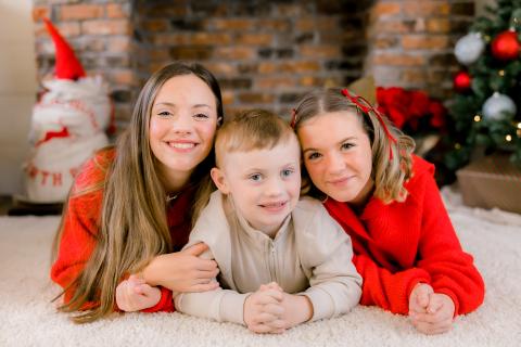 Photo contributed Cooper Godfrey, 7, poses for a Christmas photo with his older sisters, 14-year-old Annie on left, and 12-year-old Allie.