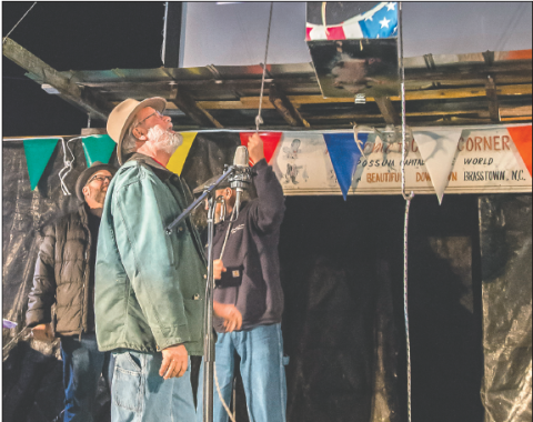 Photo courtesy Cherokee Scout Clay Logan observes the traditional lowering of the Plexiglas container that in this case, may or may not have contained a live opossum. The contained was covered, keeping viewers guessing about its contents.