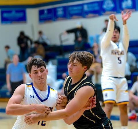Todd Sumner • Photo Landon Trout, No. 15, stakes his claim on a defensive rebound for Hayesville.