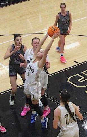 Neal Wachob • Clay County Progress Lucy Trout, No. 3, stretches for a rebound as the Hayesville trio of Trout, Ava Moore, No. 42, and Micalynn McClure, No. 10, attack the glass against Swain County.