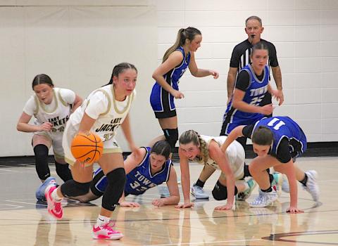 Neal Wachob • Clay County Progress Aaliyah Jackson, No. 32, is off to the races after Hayesville teammate Ava Shook, No. 2, hit the deck to wrestle the basketball away from Towns County and shove the rock to Jackson.