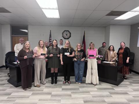 Angel Owens • Photo Newly National Board Certified teachers, front, from left, Christy McClure, third grade; Meghan Taylor, second grade; Tara Roberts, second grade; Katie Danner, third grade; Susan Rexroad, third grade and Adrianna Deaver, second grade were recognized at the Board of Education meeting. Board members, back, from left, Danny Jones, Robert Caldwell, Chairman Jason Shook, Josh Ashe, Kelly Crawford and Superintendent Melissa Godfrey congratulate the teachers.