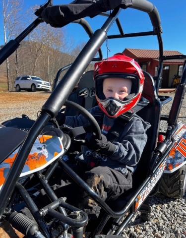 Caitlin Lovingood • Photo Rhet Lovingood was suited up for a ride through the family's backyard in Hayesville on Sunday, March 22. Rhet's gas-powered go-cart is a part of his play routine when weather is permitting.