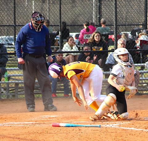 Neal Wachob • Clay County Progress Hayesville's catcher Caroline Wade looks for another Lady Brave to erase after tagging out a runner at home.