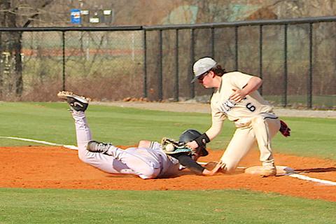 Neal Wachob • Clay County Progress The infield umpire called the runner safe on this pickoff play but it sure looks like Hayesville first baseman Landon Cheeks, No. 6, has the sack blocked as he makes the tag.