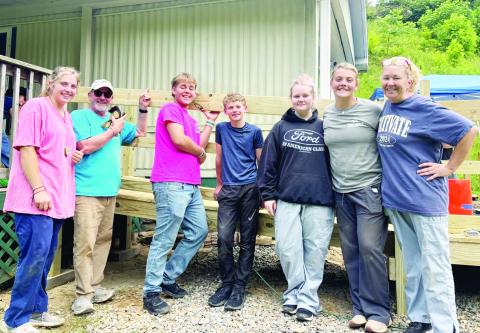 Maggie McClure, Kirk Hatherly, Ethan Koenig, Eli Danico, Polly Jones, Lillie McClure and Kelly Jones are all smiles after building a ramp for a homeowner in need.