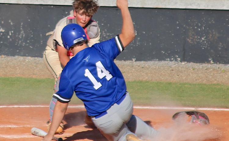 Hayesville catch Jaxson Caruso applies the tag as Hiawassee Dam's Wyatt Davenport tries to score.