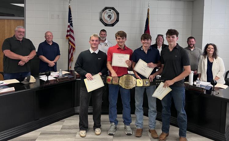 Jackets Varsity Wrestling athletes received award certificates during Clay County School Board of Education meeting on Monday, May 18, from left, Hayden Hunt, All-WNC; Evan Burkes, All-WNC and All-State; Parker Hughes, Honorable Mention and Kota Patterson, All-Conference. Back, Board members Danny Jones, Robert Caldwell, Chairman Jason Shook, Superintendent Melissa Godfrey, Board members Josh Ash and Kelly Crawford.