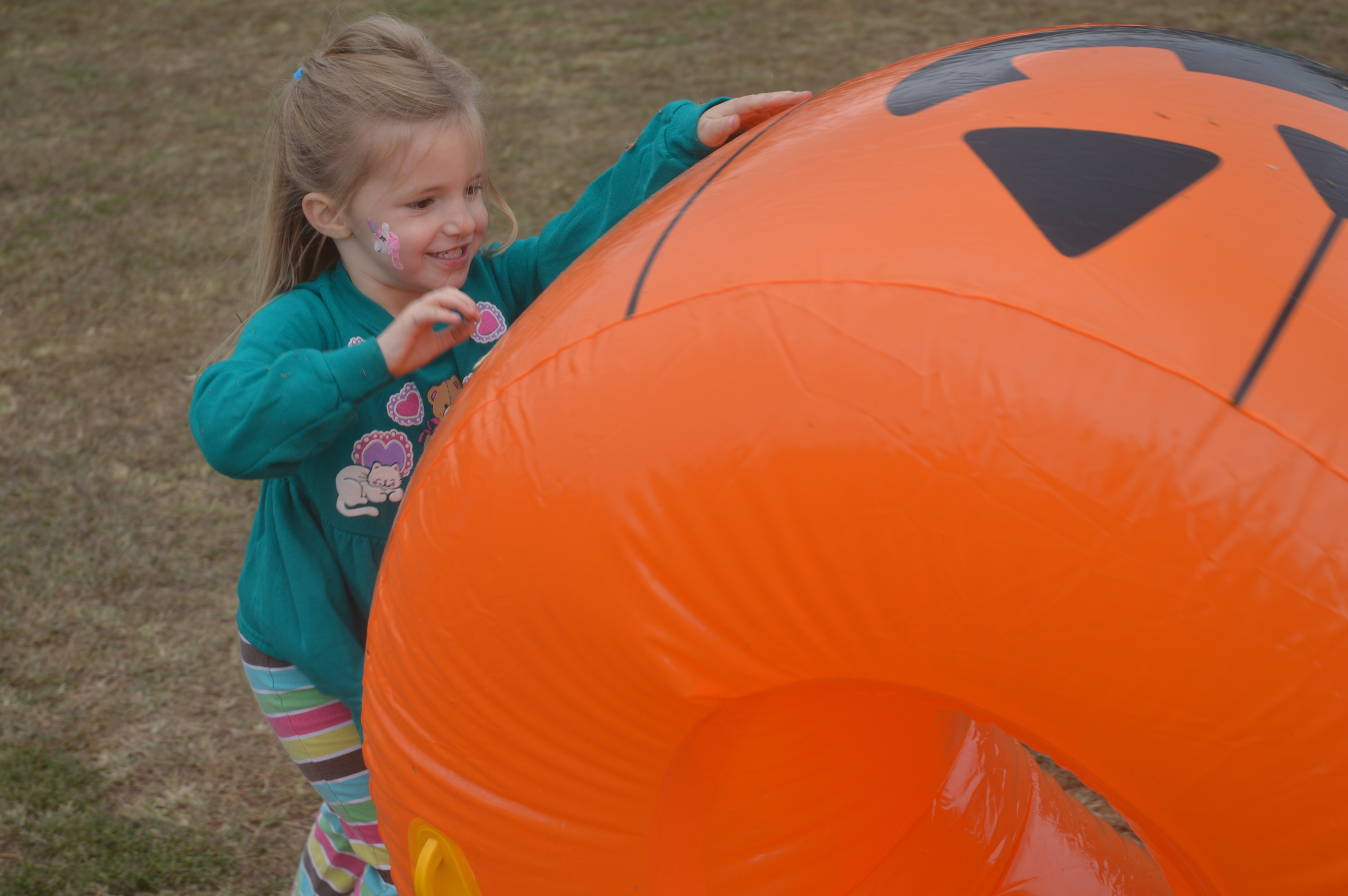 (Lorrie Ross • Clay County Progress) Four year old Harley Mott had a great time rolling an inflatable pumpkin across the kids' area.
