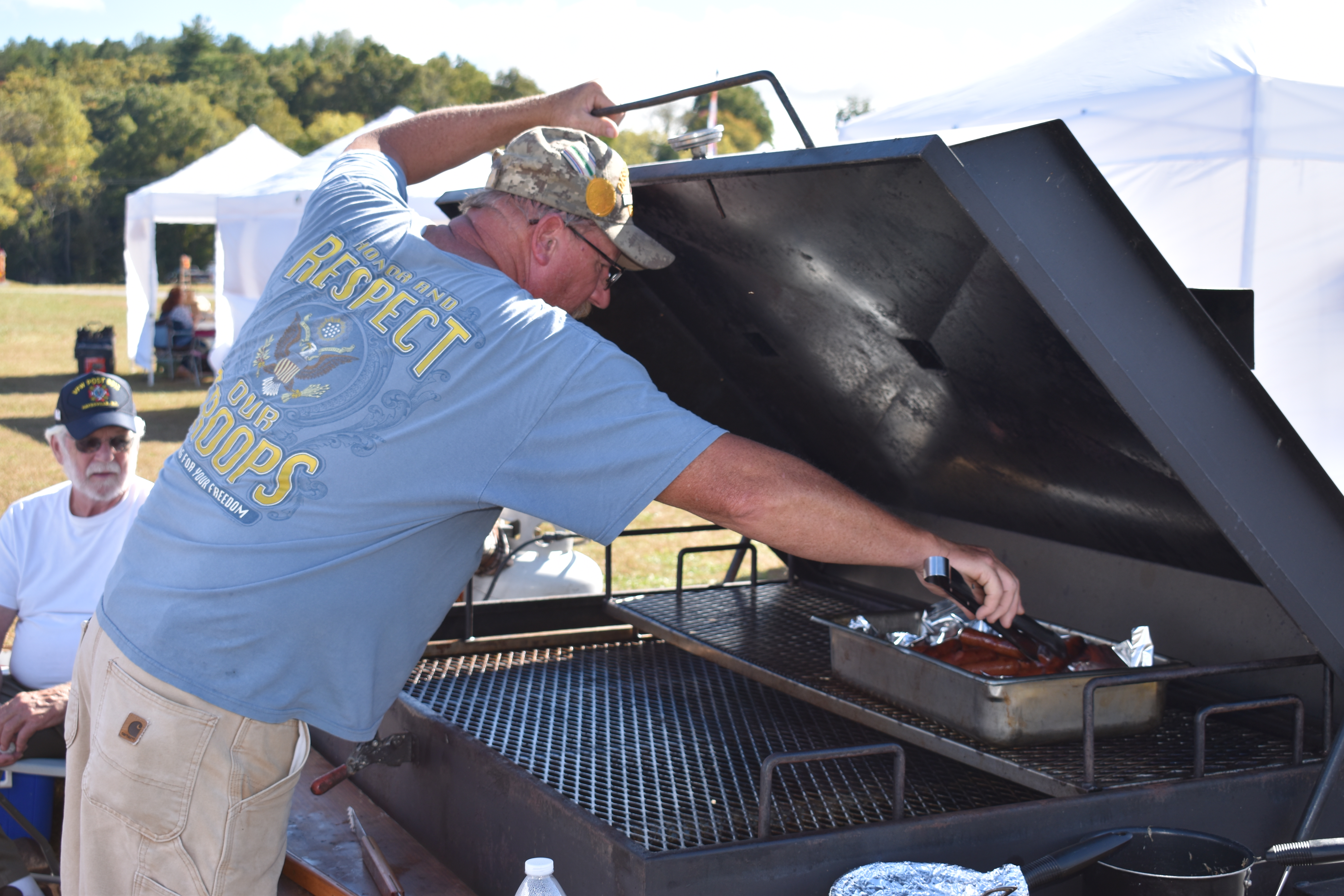 Tom Lyvers keeps the grilled hotdogs hot and ready during the festival.