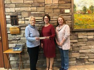 DAR presents a $500 donation. Sandie Harbuck, Chapter Librarian and Cayce Friedly, Corresponding Secretary, both of Blairsville, presented a check to Carol Knight, center, Principal of Woody Gap. 