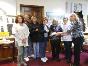 Historic Hayesville Inc. volunteers, from left, Lynn Myers, Stu Jenner, Roni Davis and HHI Board Treasurer Deborah Nichols presents a check from Steins & Wine Around the Square ticket sales totaling $7,287 to Clay County Historical & Arts Council members Dianne Burd, Sara Smith and Reba Beck for Old Jail Museum repairs scheduled for this winter. Both groups expressed appreciation to all sponsors and volunteers who made the 7th annual event a successful fundraiser.