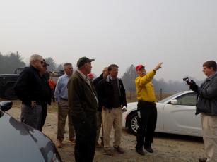 (Progress photo by Lorrie Ross)   Then NC Governor Pat McCrory made a Sunday morning trip to Clay County to see the fires in person. The forestry department’s incident command personnel point out Shooting Creek firelines from a safe distance. 
