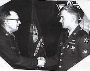 A 21-year-old James “Gary” Chamberlain receives the Purple Heart, the Silver Star and his sergeant stripes from Brig. Gen. Robert L. Ashworth.
