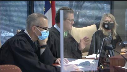 Superior Court Judges, from left, Nathaniel Poovey, Graham Shirley, and Dawn Layton oversee a trial addressing N.C. election maps. (Image from WRAL.com pool video)