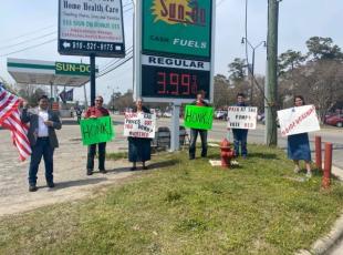 Volunteers waving signs at a gas station voter registration drive in Robeson County, N.C. (Source: RNC)