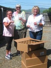 Historic Hayesville Inc. volunteers Surbrinia Baumgartner, Paula Walters and Vicky Donaldson have signature glasses ready for the 8th annual Steins & Wine event. Logo beer glasses are sponsored by Sonja Silvers Realty and wine glasses are donated each year by Advantage Chatuge Realty.