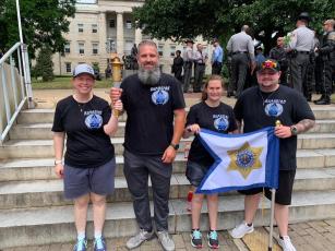 From left, Law Enforcement Torch Run Athlete Ambassadors Robin Calloway, of Mecklenburg County, Sheriff Bobby Deese, Cameron Wilson, of Union County, and Junior Captain Cameron Adams participate in the Special Olympics. Deese was a torch bearer.