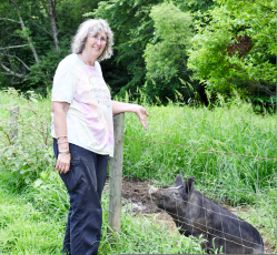 Marcia Barnes • Progress Kathy Gibby greets "Chestnut," a Berkshire pig on the family’s farm just off Fires Creek Road.