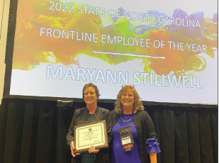 Maryann Stilwell, left, receives the NC Child Support Employee of the Year award from NC DHHS Senior Director for Human Services, Carla West during a recent ceremony in Cherokee, N.C