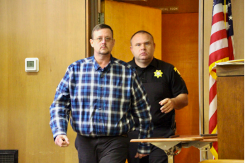 Photo • Shawn Jarrard Towns County Sheriff’s Capt. John McCoy escorting defendant Jason Matheson into the courtroom last week.