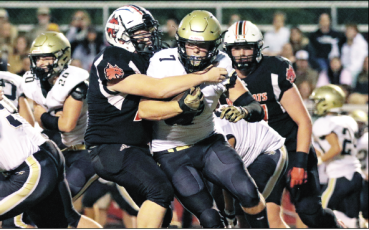 Jared Putnam • Cherokee Scout Andrews’ Taylor Waldroup tackles Hayesville’s Kyle Lunsford Thursday night at Hugh Hamilton Stadium in Andrews.