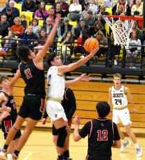 Gary Corsair • Clay County Progress Hayesville's Logan Caldwell, No. 2, glides to the basket for 2 of his 8 points in Hayesville's 66-40 win over Andrews on Saturday.