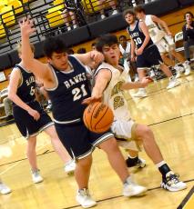 Hayesville's Jakob McClure, No. 22, fights for a loose ball during the Yellow Jackets' 72-14 victory over Nantahala.