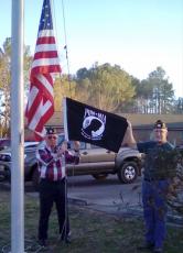 Post 532 Honor Guard member Mitchell Shields and Honor Guard Commander Dwight McClure replace the POW-MIA flag at the Clay County Care Center.