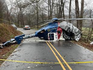 Macon County Sheriff’s Office  Wreckage of Life Force 6 blocks Middle Burningtown Road in Macon County on Friday, the morning following the helicopter crash. All four passengers aboard survived.
