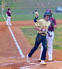 Gary Corsair • Clay County Progress Ben Bethel crosses the plate with Hayesville's first run in a 21-0 JV baseball victory at Swain last week. Bethel reached on a walk, stole second base and scored on a wild pitch. That's Kendall Boyer advancing to third.