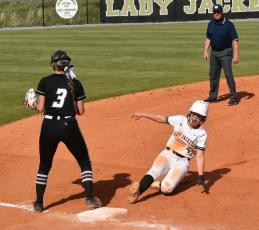 Gary Corsair • Clay County Progress Lady Yellow Jacket Faith Odell hustles into third base during a Hayesville rally against visiting Robbinsville.