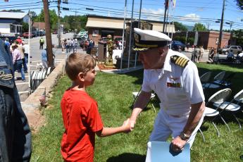 Becky Long • Clay County Progress Johnny Brown, 8, gets a warm handshake from Captain James P. Davis after Monday’s Memorial Day Service on the Hayesville square. Brown, one of few young people in the audience, said of the service, “It was good.” Davis reminded attendees that Memorial Day is more than the beginning of summer, that it serves a much greater purpose, honoring our war dead.