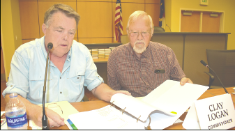 Becky Long • Clay County Progress Commissioners’ Scotty Penland and Clay Logan look over the 2023-24 budget which comprises several hundred pages. Commissioners had been studying the budget for several weeks before approving it on June 15,
