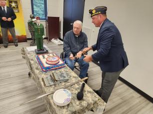 Mark Runge and Randy Fletcher performed the traditional cutting of the cake with a saber.