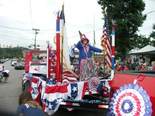 Deby Jo Ferguson • Clay County ProgressFirst Freewill Baptist Church and Carolina Christian Academy show off their patriotism with a beautiful red, white and blue float complete with Uncle Sam during Tuesday’s Fourth of July Parade on the Hayesville town square. Crowd size appeared much larger than in previous years. Visitors enjoyed games, music, food and the parade procession  which included cars, extravagant floats and a slew of spectators on the sidelines. The day marked America’s 247th birthday. In the