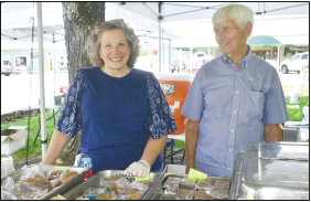 Becky Long • Clay County Progress Volunteers Suzanne Hanson and Bob Rogers are ready to serve at the food booth. Among the popular offerings were Mexican corn and generously filled barbecue sandwiches.