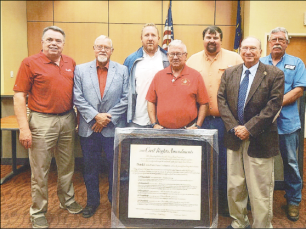 Betty Bradley • Photo Commissioners are presented a framed replica of Civil Rights Amendments during their Aug. 3 meeting. From left, Commissioners’ Scotty Penland, Clay Logan, Rob Peck, Randy Nichols and Dwight Penland. Making the presentation are, in front, Ron Lewis and Dr. David Streater of Foundation Forward.