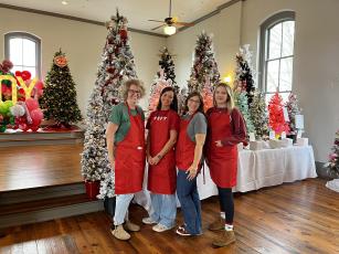 Deby Jo Ferguson • Clay County Progress Festival of Trees, making it come together from left, Tracy Cothren, Amanda Wagoner, Michelle Moore and Adeison Sorrells.